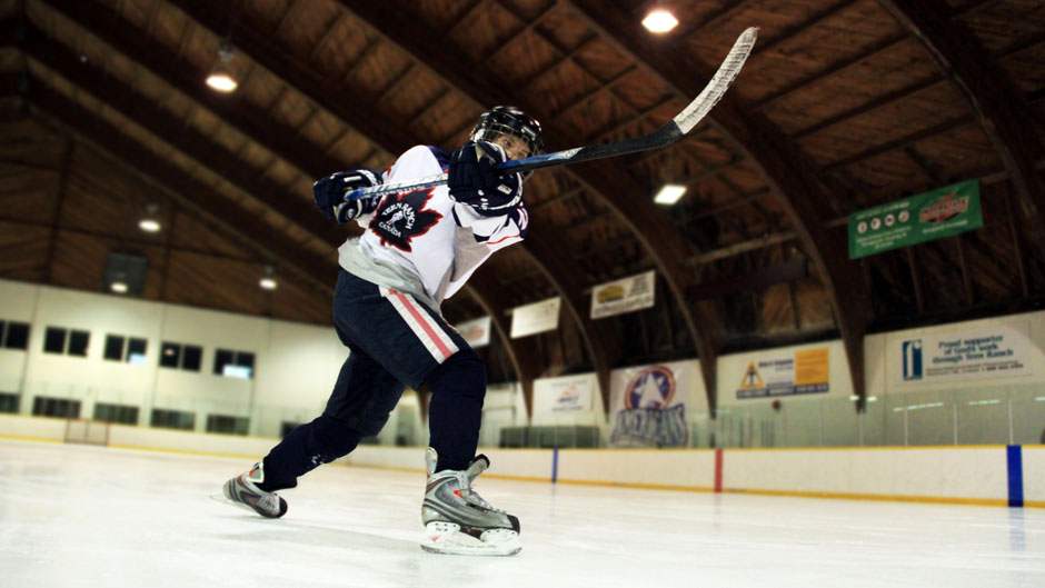 Hockey player taking a slapshot